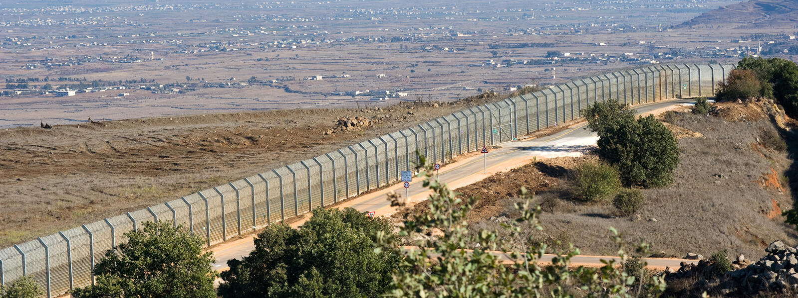 Long fenced border between countries.